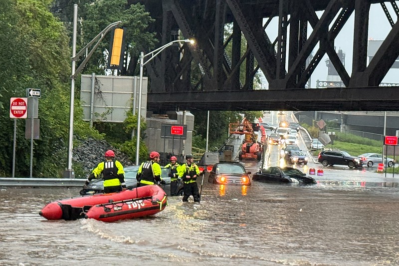 In this photo provided by the City of Jersey City, first responders try to rescue people stranded in a flooded street in Jersey City, N.J., Thursday, Aug. 20, 2026, after storms went through the area. (City of Jersey City via AP)