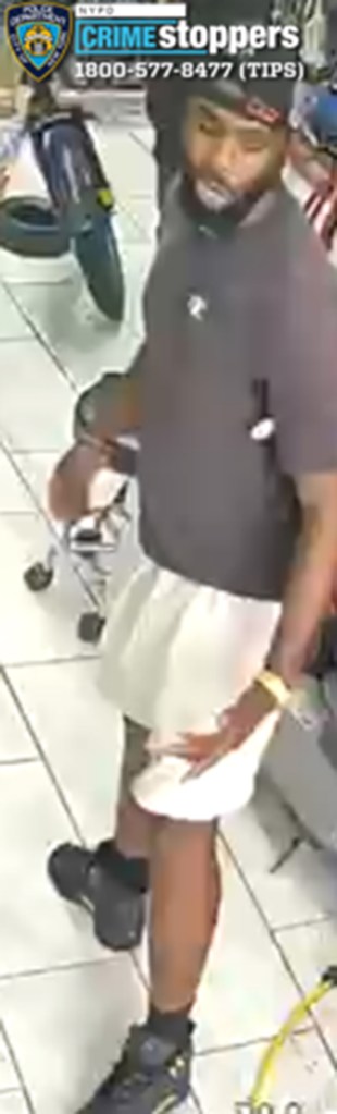 Suspect wanted for assault in Brownsville, New York, wearing a dark gray t-shirt and white shorts.