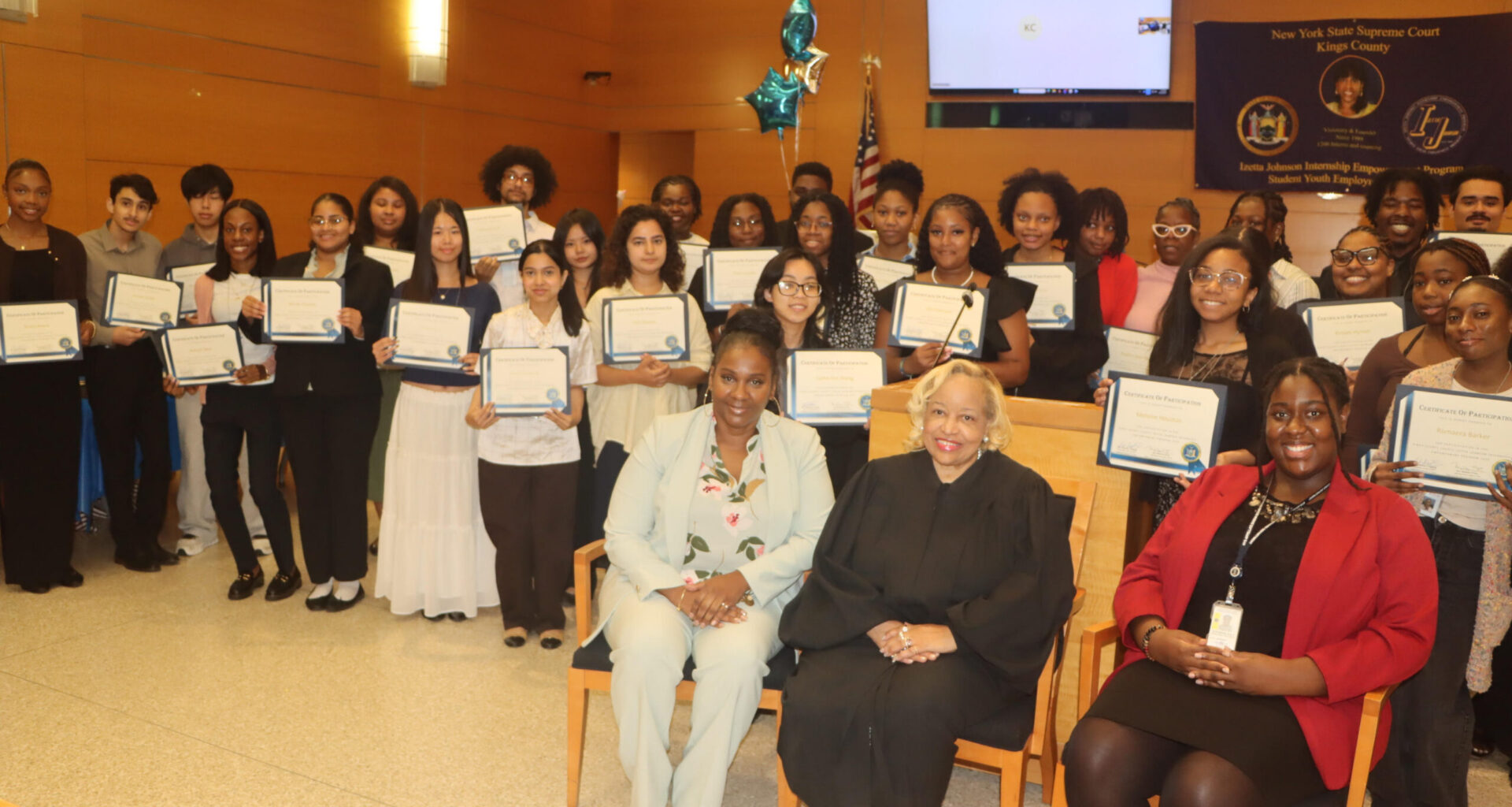 Nicole Smith, Hon. Deborah Dowling and Jennifer Joly alongside 2026 interns holding their certificates. Photo: Mario Belluomo/Brooklyn Eagle