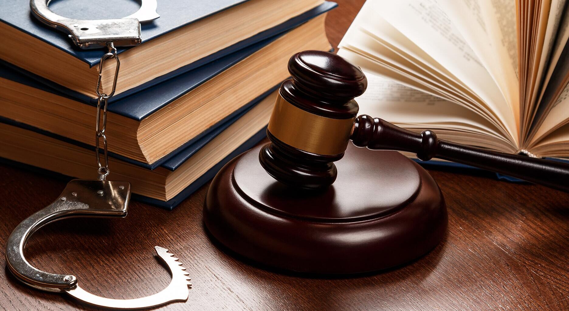 Stock image of gavel, handcuffs, and law books