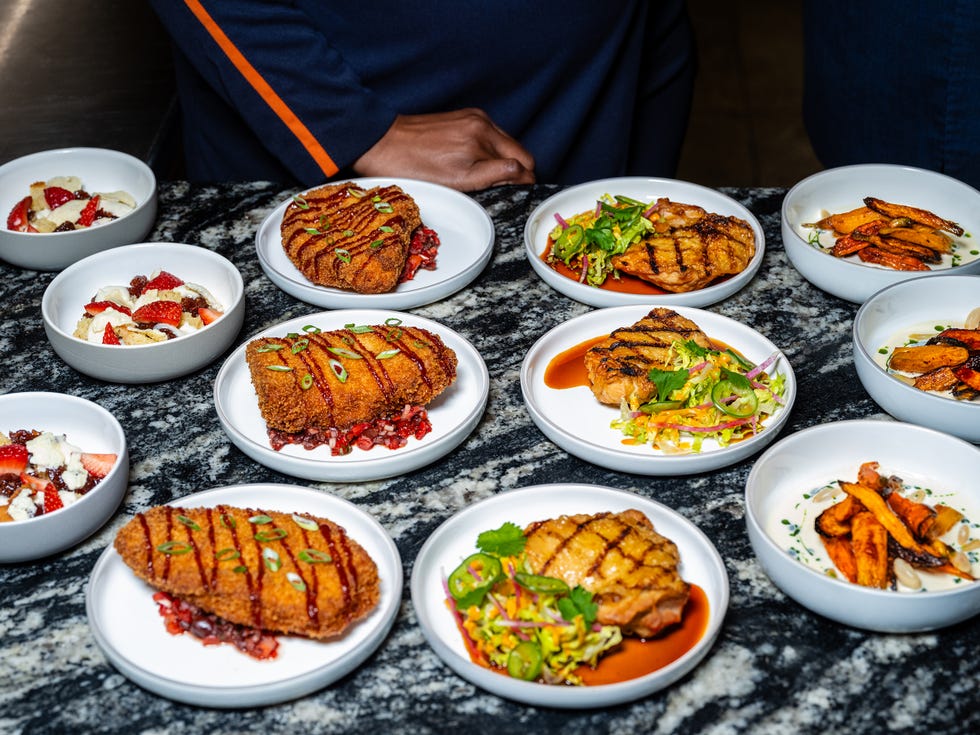 An assortment of grilled and fried dishes served on white plates, accompanied by sides and desserts. An assortment of grilled and fried dishes served on white plates, accompanied by sides and desserts.
