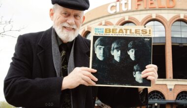 Dennis Livesey holds his vintage “Meet The Beat­les!” album cover at the former location of Shea Stadium, currently the parking lot of Citi Field. Photo: David Paone