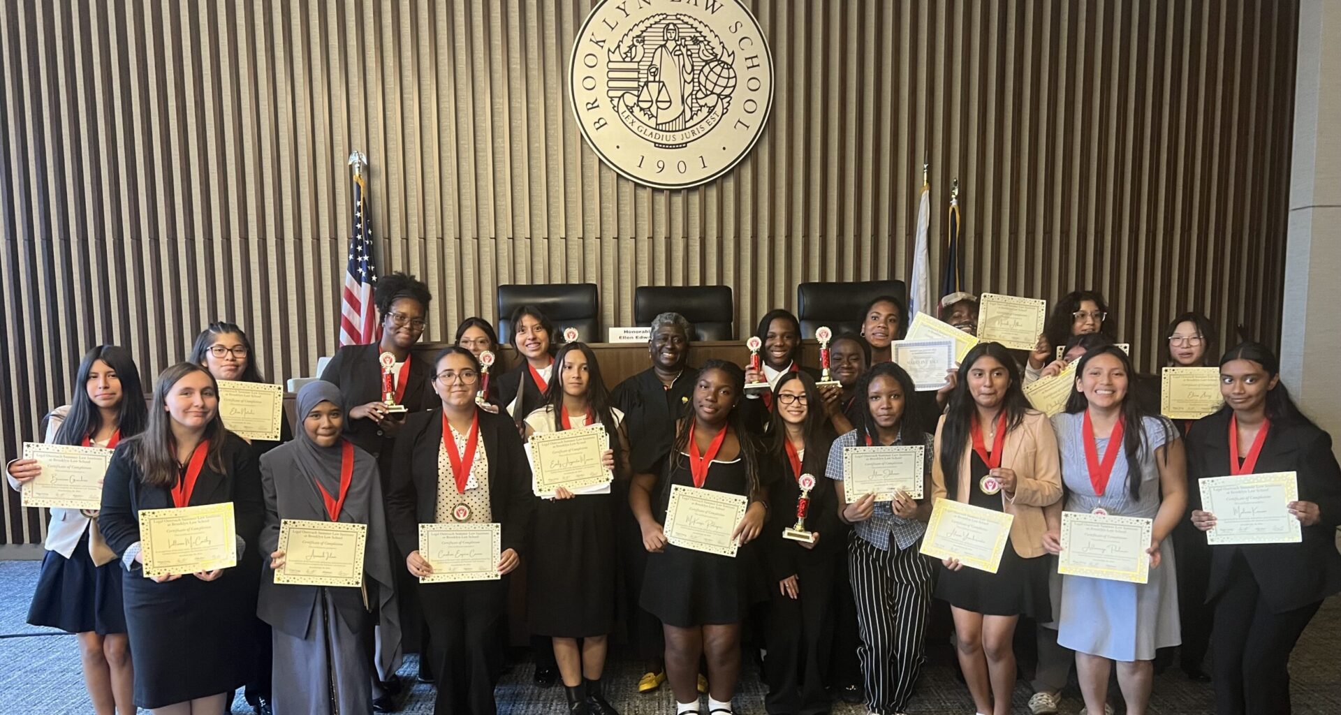 Hon. Ellen Edwards, center, alongside graduates of the Legal Outreach Summer Law Institute displaying their certificates of completion. Photo: Wayne Daren Schneiderman/Brooklyn Eagle