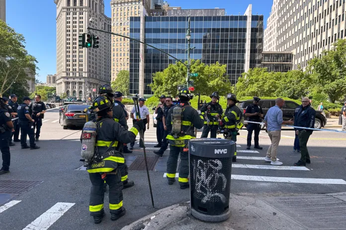 The New York City Fire Department and law enforcement respond to an incendiary device outside the New York federal building in lower Manhattan, Monday, July 20, 2026, in New York.