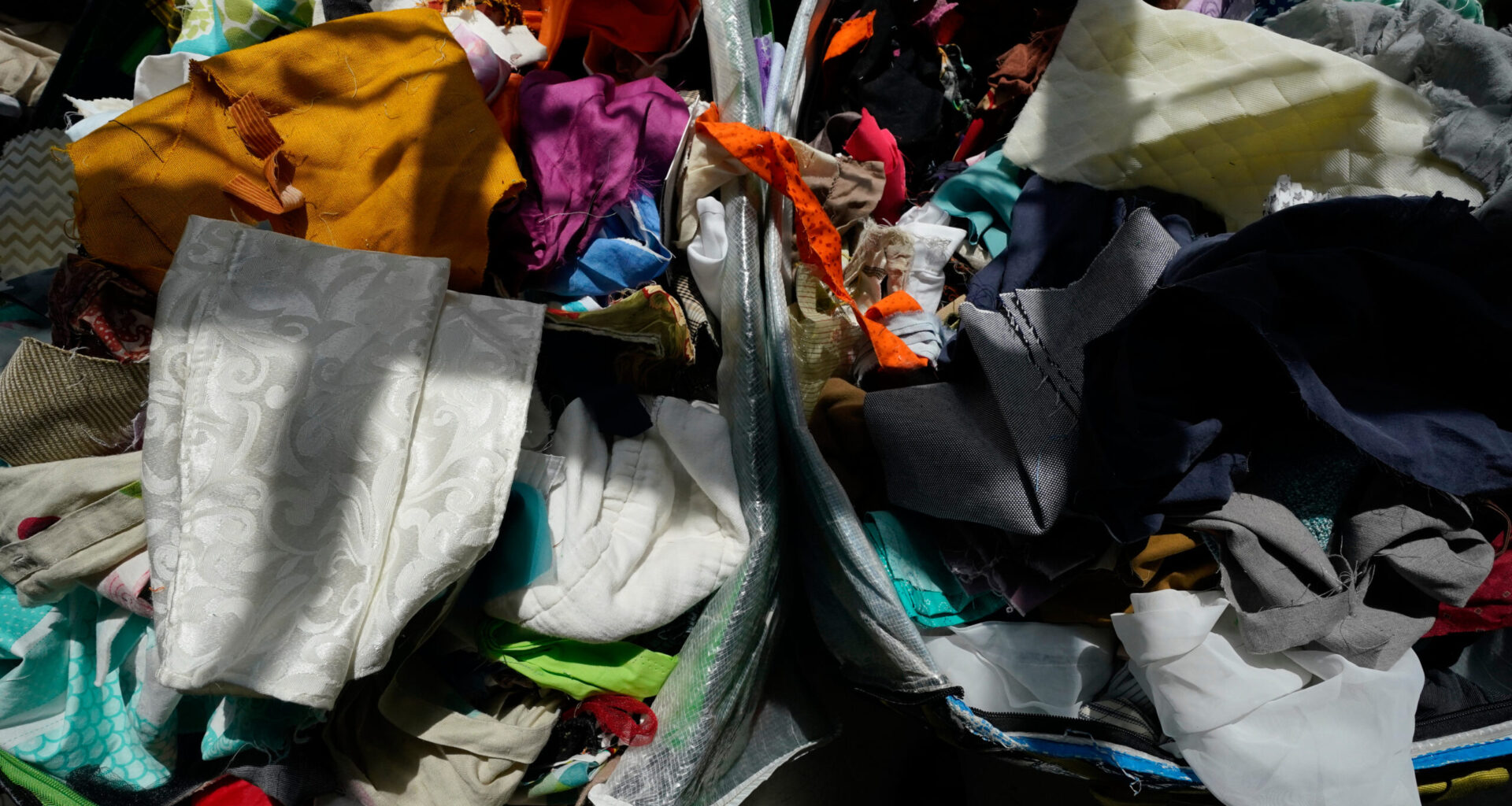 Fabric pieces sit for sale in bins at the Brooklyn Creative Reuse, Wednesday, July 29, 2026, in Brooklyn borough of New York. (AP Photo/Alyssa Goodman)