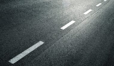 close up of white dotted line on asphalt road