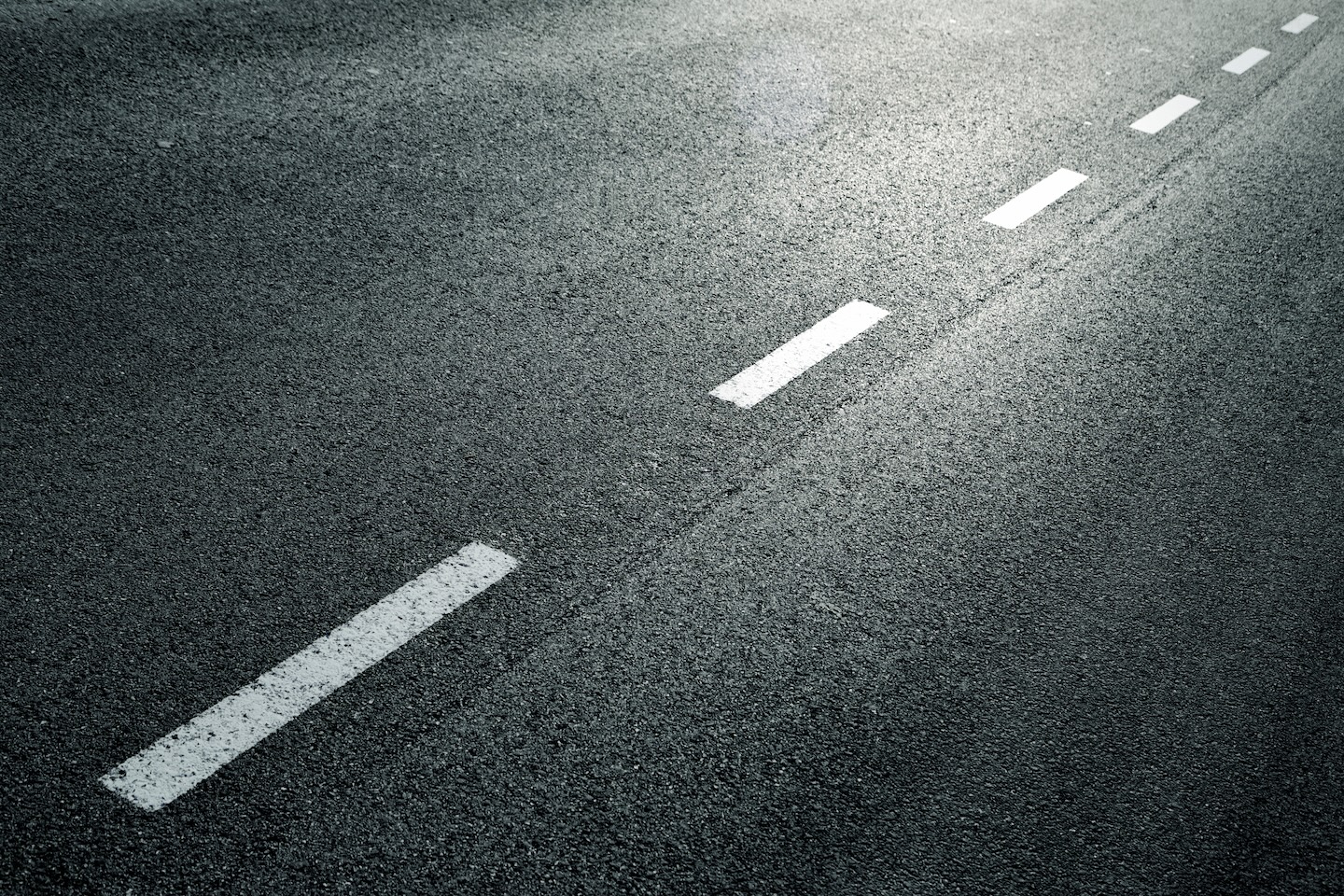 close up of white dotted line on asphalt road