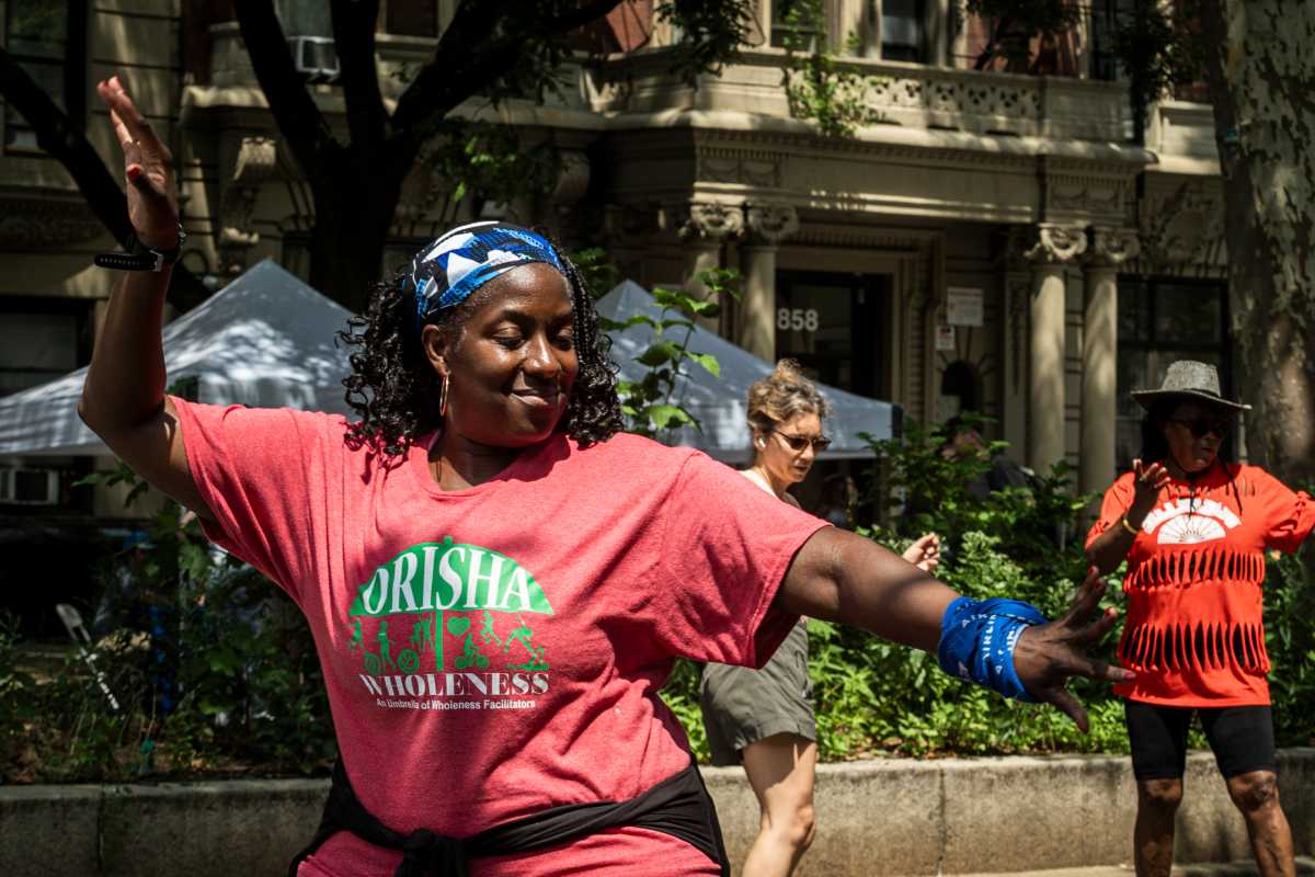 Vice-President and Board Chair for Orisha Wholeness, Shelly Wilson, joins the line dance to show off some moves.
