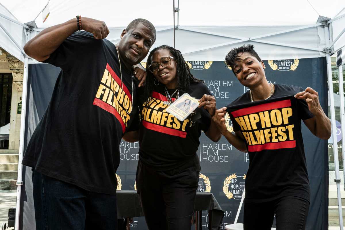 Team members James, Kim, and Nina show off their Hip Hop Film Fest Merch