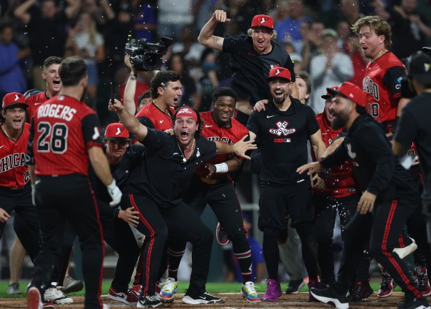 Teammates wait at the plate as White Sox catcher Jake Rogers (28) arrives to score after hitting a two-run walk-off home run in the ninth inning against the Mets on Aug. 21, 2026, at Rate Field. (Chris Sweda/Chicago Tribune)