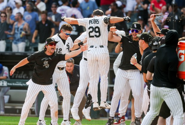 Chicago White Sox players celebrate with center fielder Tristan Peters (29) after he hit a home run in the ninth inning to win the game 2-1 against the New York Mets at Rate Field on Aug. 23, 2026. (Eileen T. Meslar/Chicago Tribune)