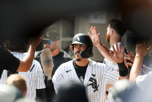 Chicago White Sox third baseman Miguel Vargas (20) gets high-fives in the dugout after scoring in the eighth inning against the New York Mets at Rate Field on Aug. 23, 2026. (Eileen T. Meslar/Chicago Tribune)
