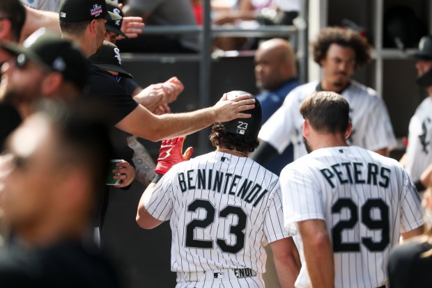 Chicago White Sox designated hitter Andrew Benintendi (23) gets high-fives in the dugout after he hit an RBI double in the eighth inning against the New York Mets at Rate Field on Aug. 23, 2026. (Eileen T. Meslar/Chicago Tribune)
