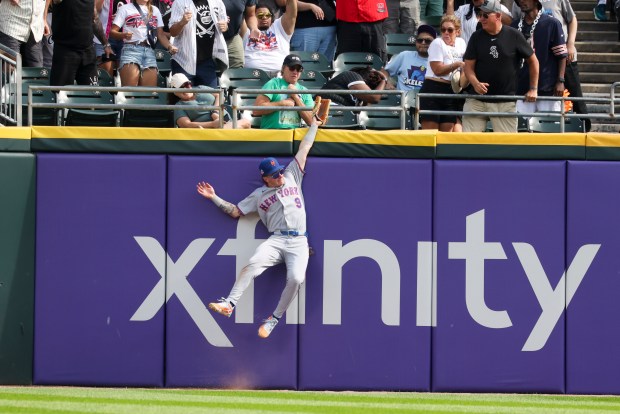 New York Mets center fielder A.J. Ewing (9) jumps up to try to catch a fly ball from Chicago White Sox center fielder Tristan Peters (29) in the ninth inning at Rate Field on Aug. 23, 2026. (Eileen T. Meslar/Chicago Tribune)