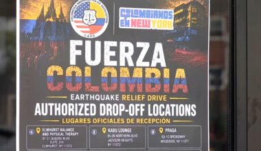 Flags hang outside businesses while boxes of donations are now stacking up inside one of them. (Spectrum News NY1)