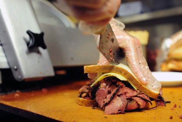 A chef cuts a pastrami sandwich in half at the Carnegie Deli in 2011. (Bryan Smith for New York Daily News)