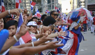 Crowds call for give away souvenirs and cheer during the Dominican Day Parade, Sunday Aug. 13, 2017, in New York. (AP Photo/Bebeto Matthews)