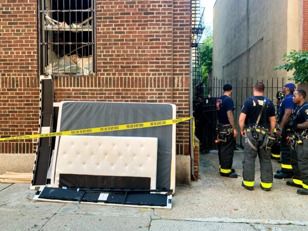 Firefighters examine the scene after the 35 Orange St. fire on Sunday. Photo: Mary Frost/Brooklyn Eagle