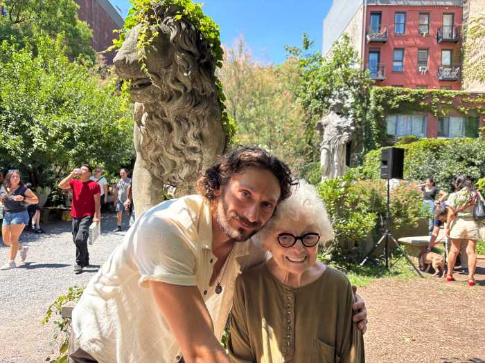 man and woman posing for a picture in a garden