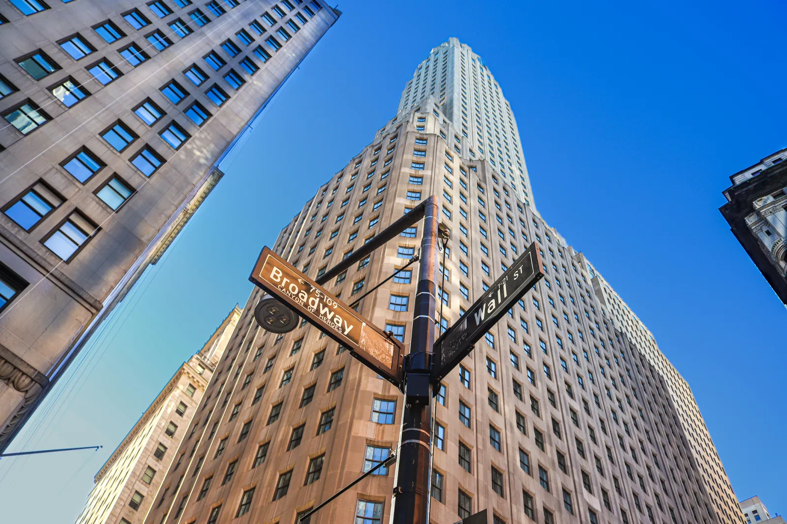 A view up a high-rise building at the corner of Broadway and Wall Street in Lower Manhattan.