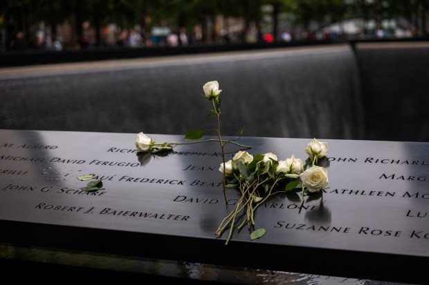 Flowers are placed on victims' names at the National September 11 Memorial & Museum.