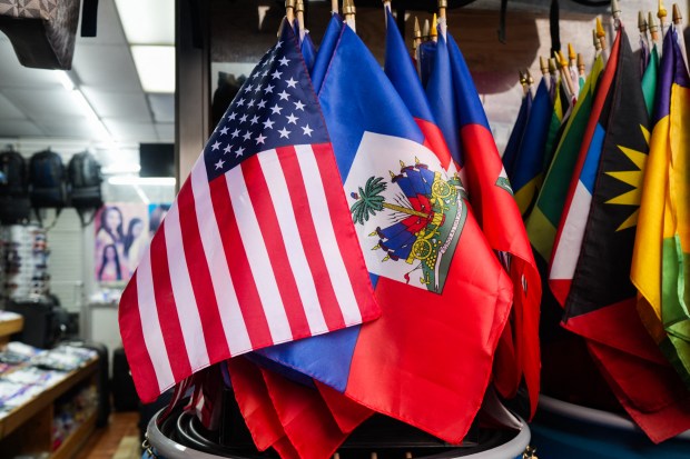 US and Haitian flags lay next to each other in a store in the Little Haiti neighborhood of Brooklyn, New York, on July 29, 2026. Tens of thousands of Haitians faced the prospect of leaving the United States or being deported, with the special protected status allowing them to live and work legally in the country set to expire on Aug. 3, 2026. The US Supreme Court said last month the Trump administration could end Temporary Protected Status (TPS) for Haitians and some 6,000 Syrians without judicial review, although the impact of the decision could apply to migrants from many other backgrounds. (Photo by Ryan MURPHY / AFP via Getty Images)