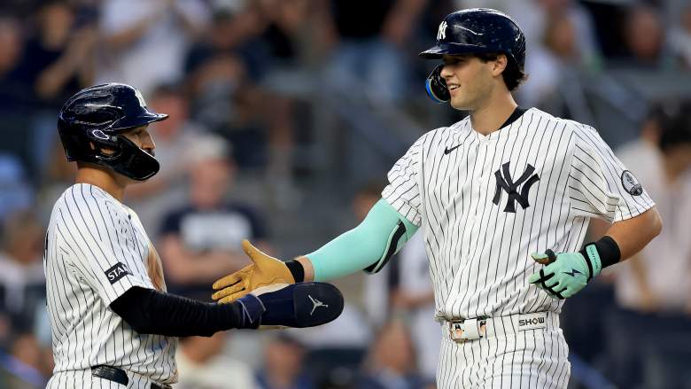 New York Yankees' Spencer Jones shaking hands with Trent Grisham during a game