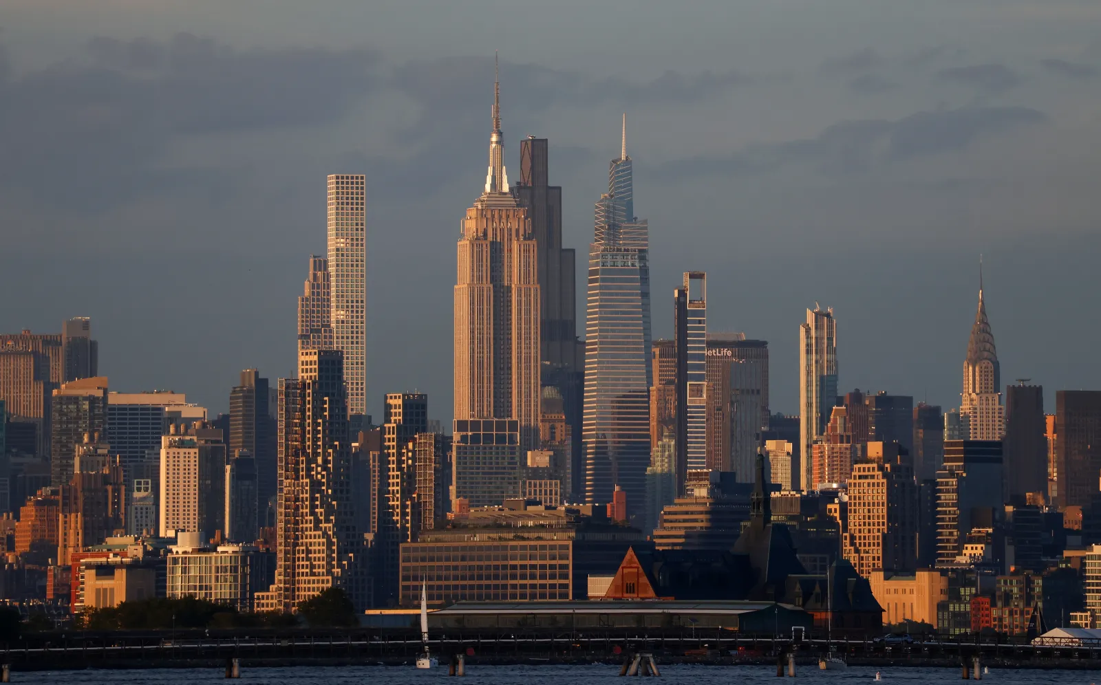 The sun sets on the skyline of midtown Manhattan and the Empire State Building in New York City on August 26, 2026, as seen from Jersey City, New Jersey.