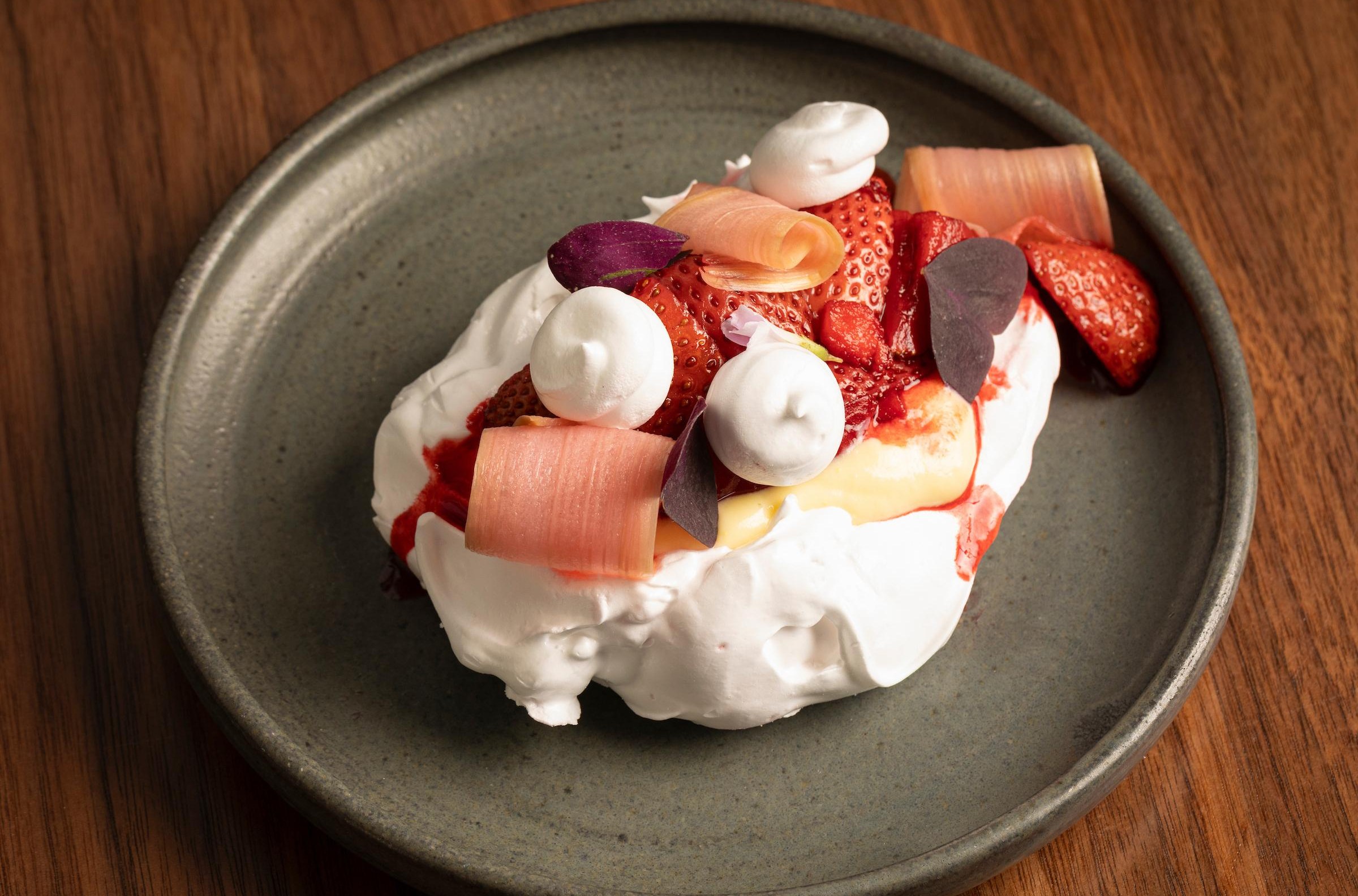 A white meringue with berries.