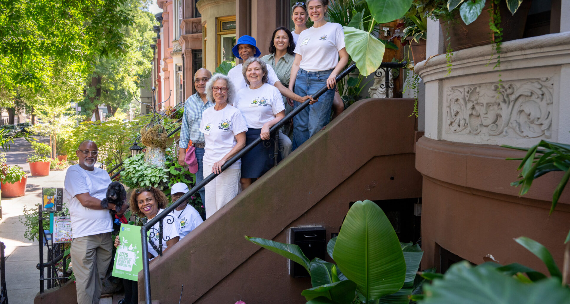 The 2026 Greenest Block in Brooklyn’s winning team, P.L.A.N.T., on a Lincoln Place stoop. Photo: Jeremy Weine/BBG