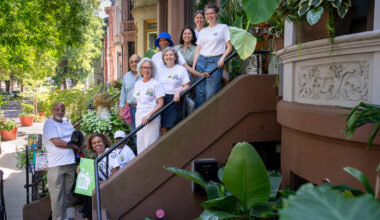The 2026 Greenest Block in Brooklyn’s winning team, P.L.A.N.T., on a Lincoln Place stoop. Photo: Jeremy Weine/BBG