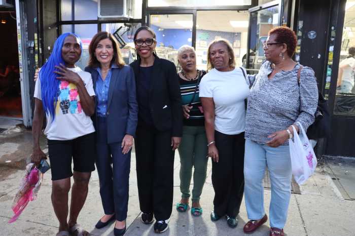 Gov. Kathy Hochul, second from left, City Council Member Rita Joseph, third from left, with community residents outside Hello Bar and Restaurant on Nostrand Avenue in Brooklyn.