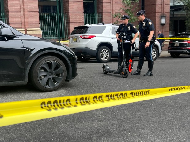 Police on the scene of W. 60th St. in Manhattan, where a scooter driver was struck by a Tesla on July 30, 2026. (Barry Williams/ New York Daily News)