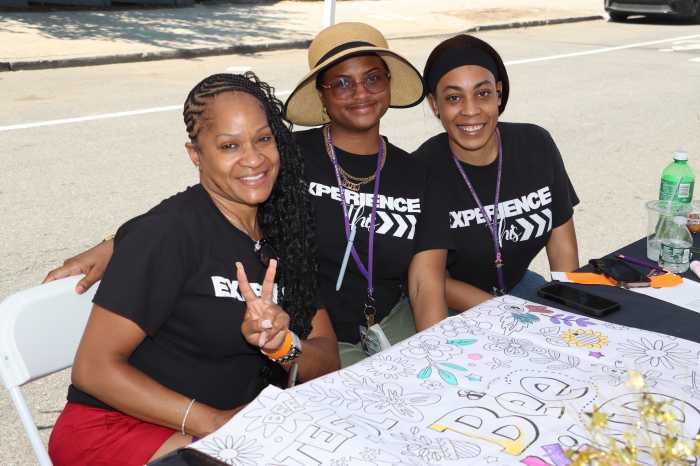 Employees from the Patient Experience Department at Brookdale University Hospital display a chart in which patrons can draw "community colors."