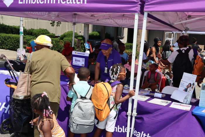 Adults and kids at the EmblemHealth tent.