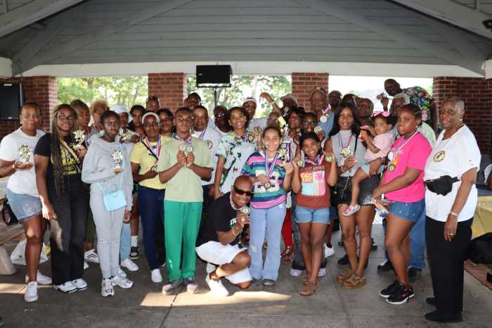 Hyacinth Robinson-Goldson, the Jamaican-born IUOM Community Liaison Officer, right, front, with recipients of trophies and medallions with their children.