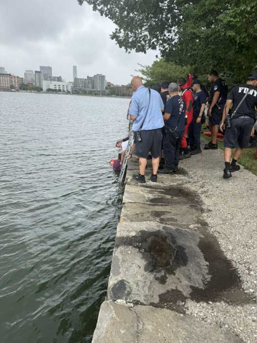 first responders rescuing a woman from the East River