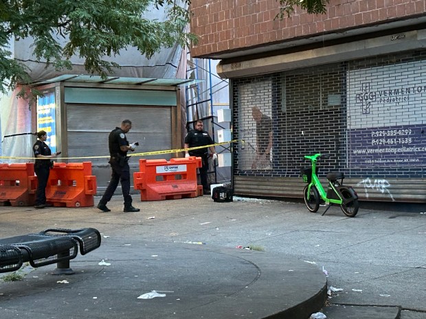 Two men sitting on a bench at E Tremont and Boston Rd in the Bronx were shot by a hooded gunman on Aug. 6, 2026. (Kerry Burke/New York Daily News)