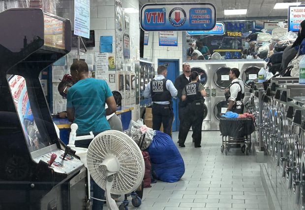 Police investigate Monday night after Jose Scott was stabbed to death in an altercation that started at the Laundry Cycle Super Store laundromat on Merrick Blvd. in Queens. (Kerry Burke / New York Daily News)