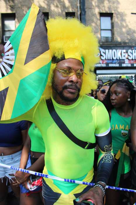 A spectator, decked out in Jamaican colors, strikes a pose at the Jamaica Rising Day 2026 parade on August 8, in Brooklyn.