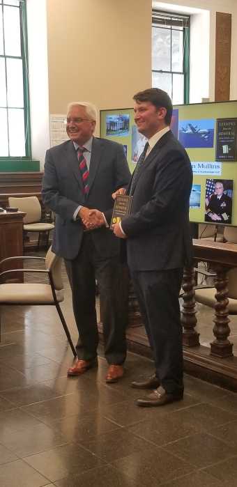 two men in suits standing in a courtroom 