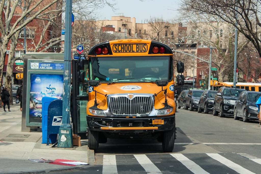 03-15-2022, New York, classic yellow school bus parked on a street in the Williamsburg neighborhood of New York City.