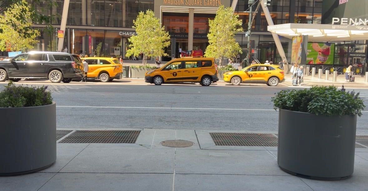 Three people were caught on video emerging from this Midtown Manhattan manhole — but no one knows who they are or what they were doing