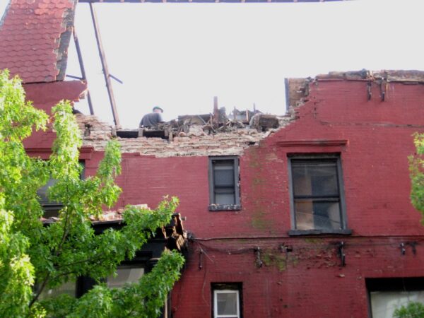 A demolition worker can be seen on top of 1 Monroe Pl. (aka 100 Clark St.) in May 2008. Photo: MK Metz, McBrooklyn blog