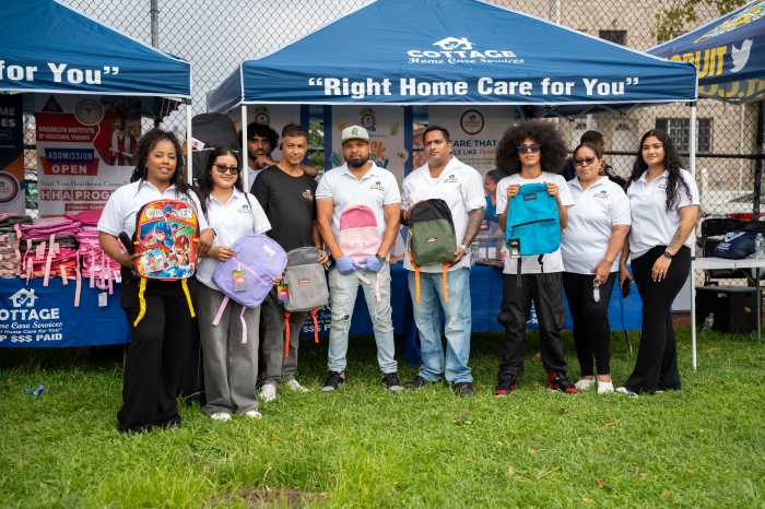Cottage Home Care Services staff help distribute backpacks and school supplies to students preparing for the new school year.