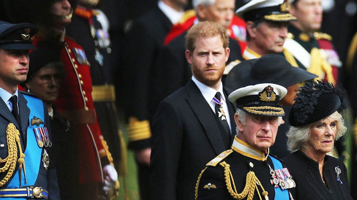 Prince Harry looking somber as he marches behind his father King Charles and stepmother Queen Camilla.