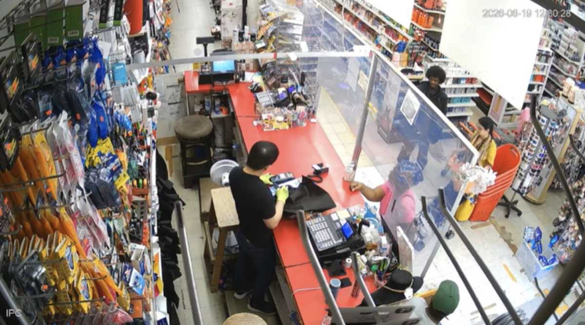 The suspect, dressed in black, on line in a convenience store near the church the day of the fire. Image via Eastern District of New York