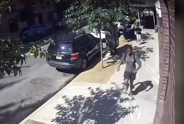 Building surveillance footage shows two men running out from under the scaffolding after the attack (pictured). One of the men was grasping his stomach. (Obtained by Daily News)