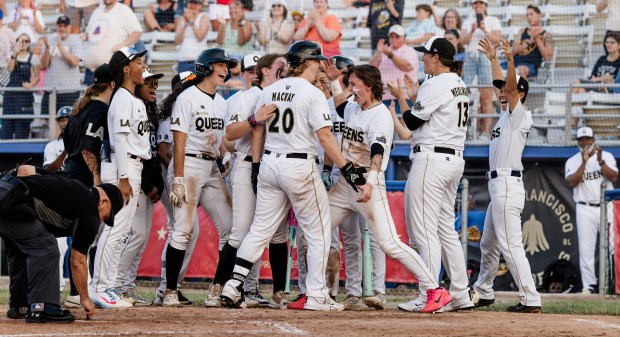 As former Rockies player Eric Young looks on from the dugout, the Los Angeles Queens celebrate during a 2026 game in the Women's Pro Baseball League at Robin Roberts Stadium in Springfield, Illinois. (Courtesy of Holly Desautels/Women's Pro Baseball League)