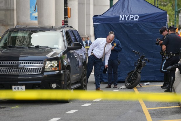 NYPD officers and detectives investigate a fatal e-bike collision on Centre St. near Chambers St. in Lower Manhattan on Wednesday, July 29, 2026 in New York City. (Barry Williams/ New York Daily News)